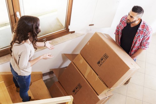 Professional movers packing office equipment for a Docklands move